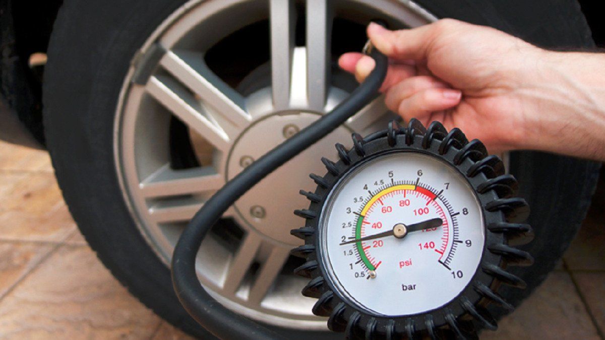 Image showing car tyre air pressure being measured